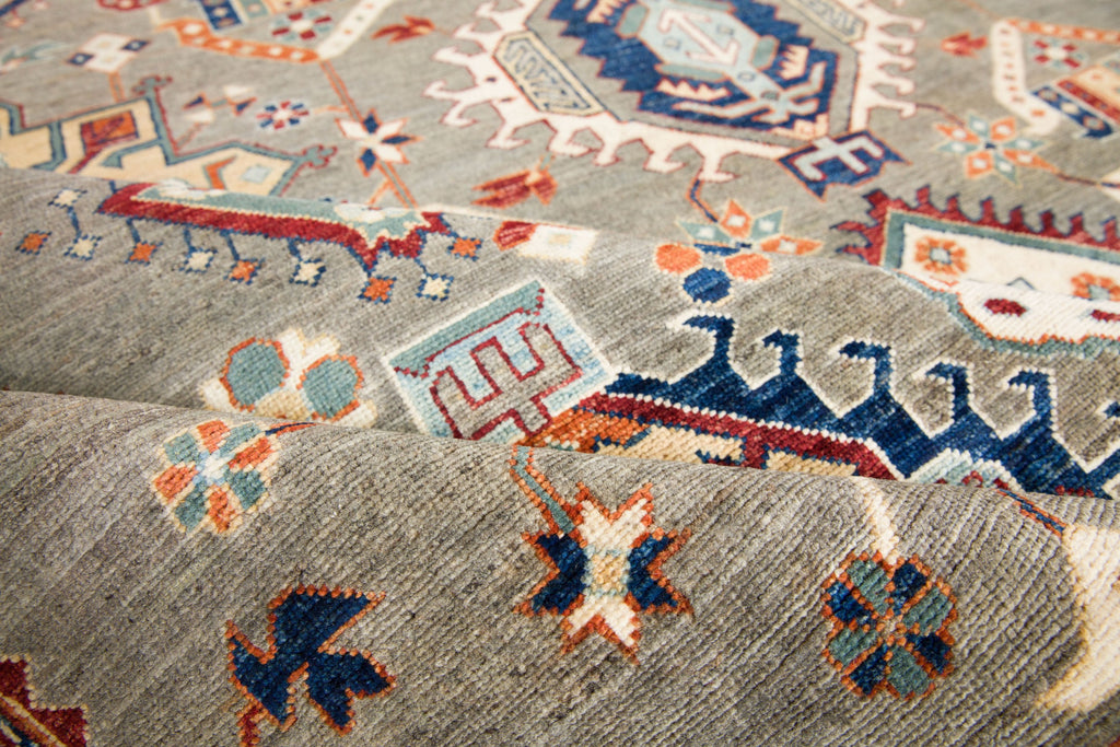 6x9 hand knotted quality oriental southwest tribal wool rug in elephant grey and ivory with deep wine red, teal accent, green, navy blue, gold and ivory colors with geometric design. Roya Rugs Asheville North Carolina.