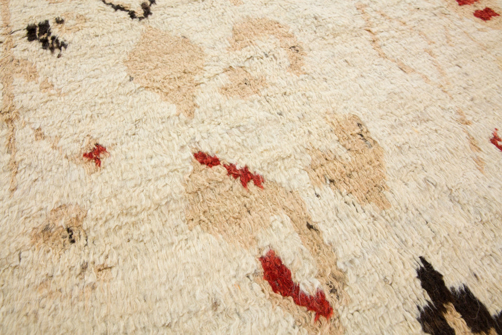 7x10 hand knotted luxury geometric wool rug with tan, neutral earth tones, and red colors perfect for cabin, ranch and mountain homes with bulls. Soft Bohemian style Moroccan berber rug from Roya Rugs in Hickory North Carolina.