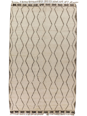 7x11 Moroccan berber wool rug with all over trellis pattern in neutral ivory beige color and accent black and brown with long tassels by Roya Rugs North Carolina