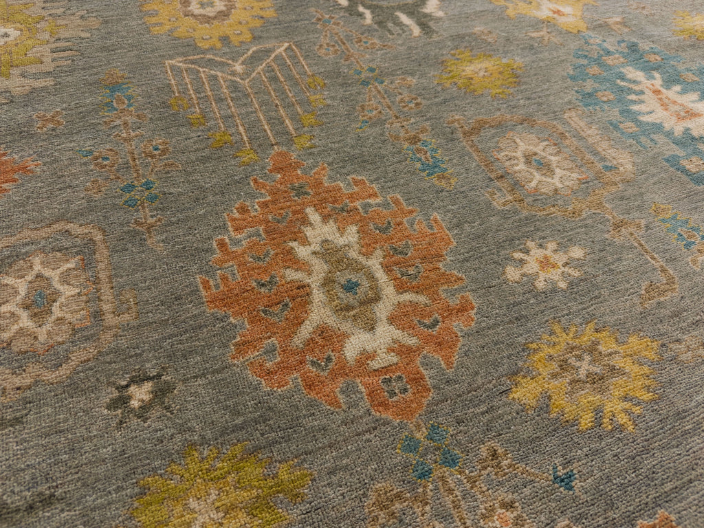 Roya Rugs North Carolina hand knotted one of a kind colorful modern Persian oriental wool rug 9 x 12 with blue grey, citron yellow, citrus, blue, brown, and orange accent colors and floral traditional design with low pile texture and lanolin natural fiber.