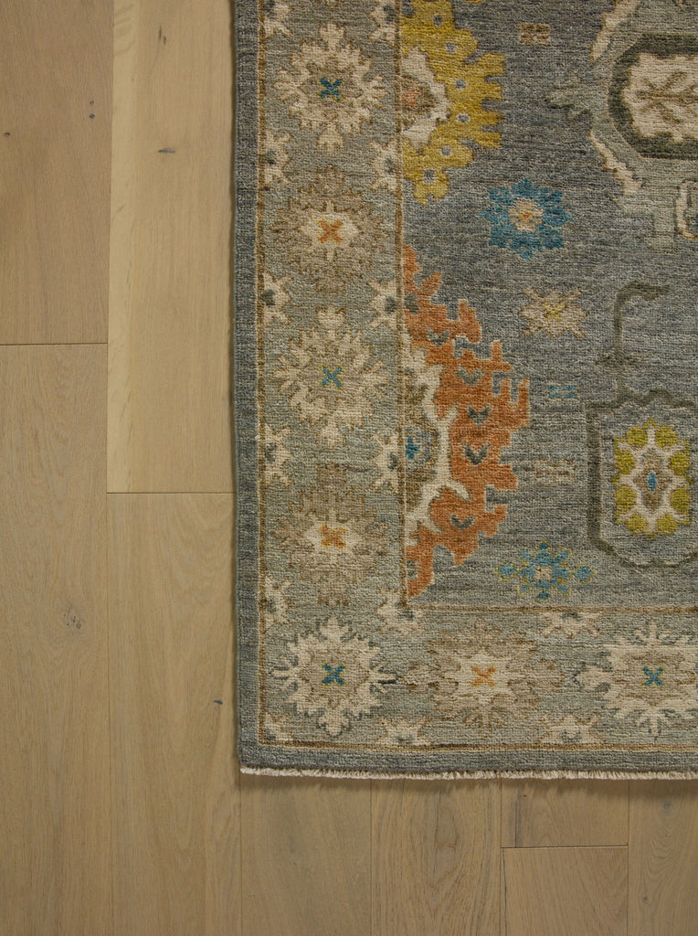 Roya Rugs North Carolina hand knotted one of a kind colorful modern Persian oriental wool rug 9 x 12 with blue grey, citron yellow, citrus, blue, brown, and orange accent colors and floral traditional design with low pile texture and lanolin natural fiber.