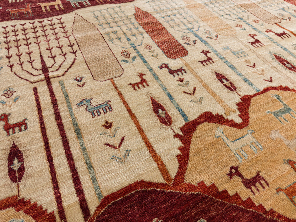 Roya Rugs Hickory North Carolina 9x12 handmade modern red tribal wool rug with ivory, green, beige, light blue and orange with animals, goats, sheep, and mountain hills.