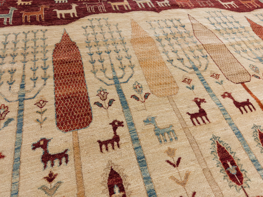 Roya Rugs Hickory North Carolina 9x12 handmade modern red tribal wool rug with ivory, green, beige, light blue and orange with animals, goats, sheep, and mountain hills.