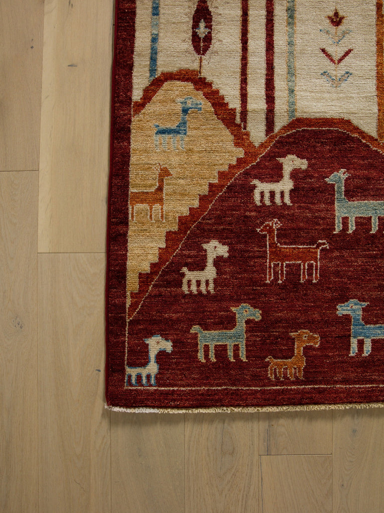 Roya Rugs Hickory North Carolina 9x12 handmade modern red tribal wool rug with ivory, green, beige, light blue and orange with animals, goats, sheep, and mountain hills.