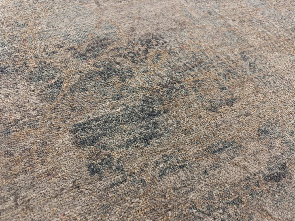 Warm grey, bluish teal low pile rug.