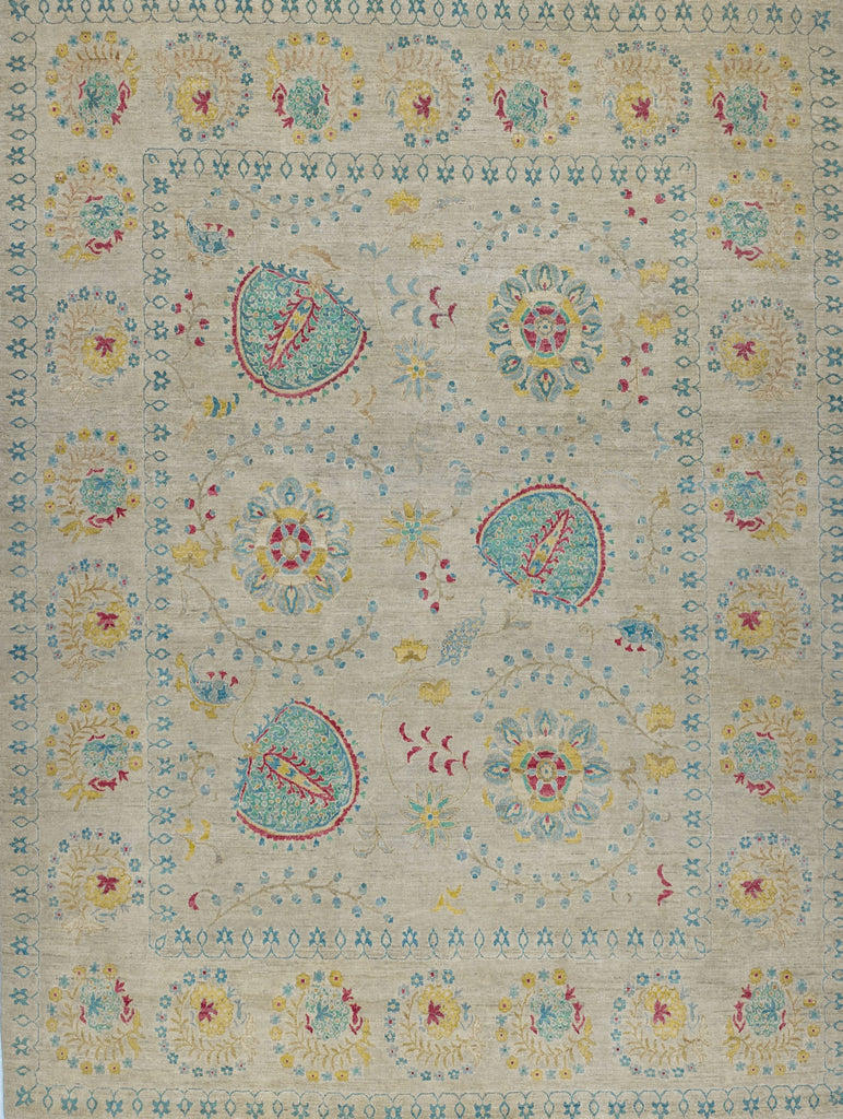 Hand knotted 8x10 wool area rug with floral suzani rug design and grey/beige background and colorful turquoise, teal, blue, bright yellow/gold, and coral red accent colors.