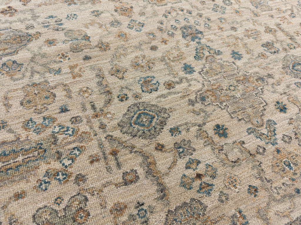 Teal blue accent area rug with sand colors and floral design.