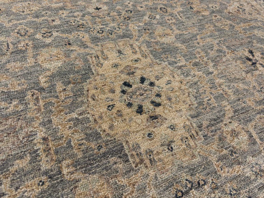 Center medallion rug with slate blue, midnight black and tan floral design.