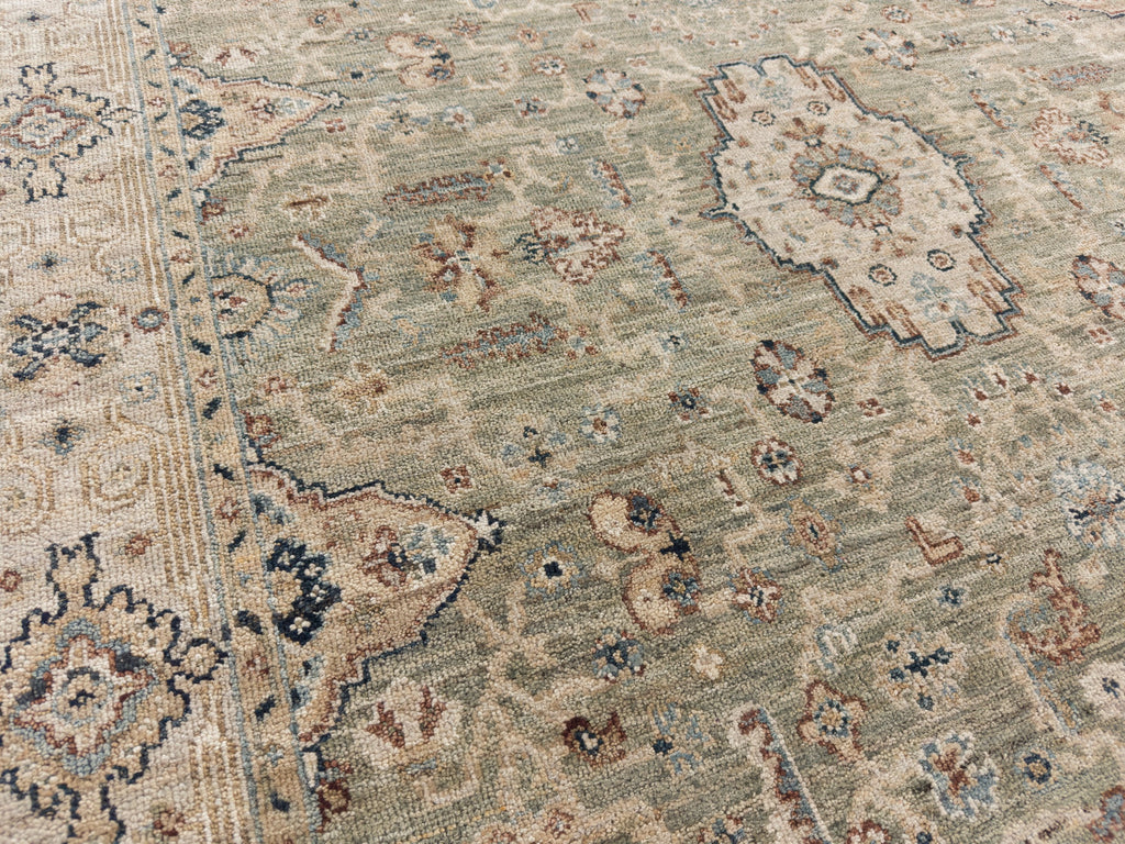 Traditional sage rug with navy blue, beige and brick red.