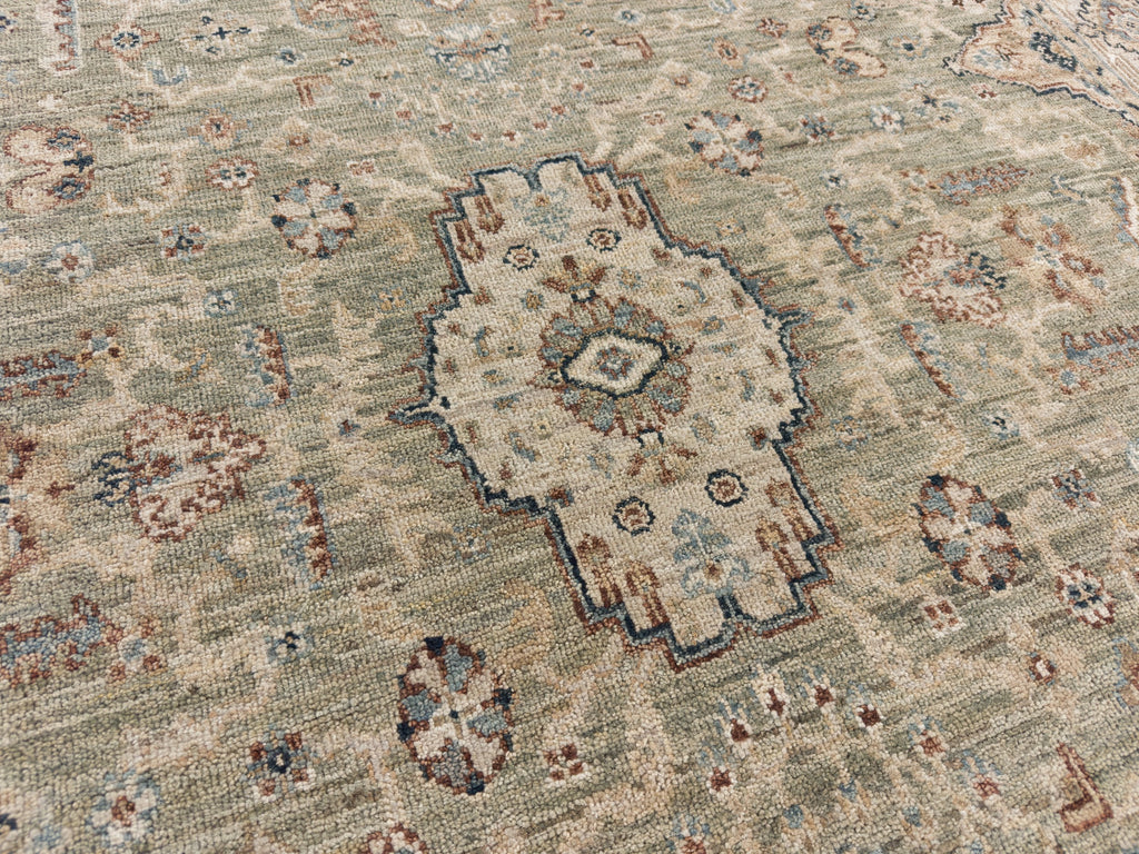 Persian medallion rug with sage green, beige, light blue and brick.