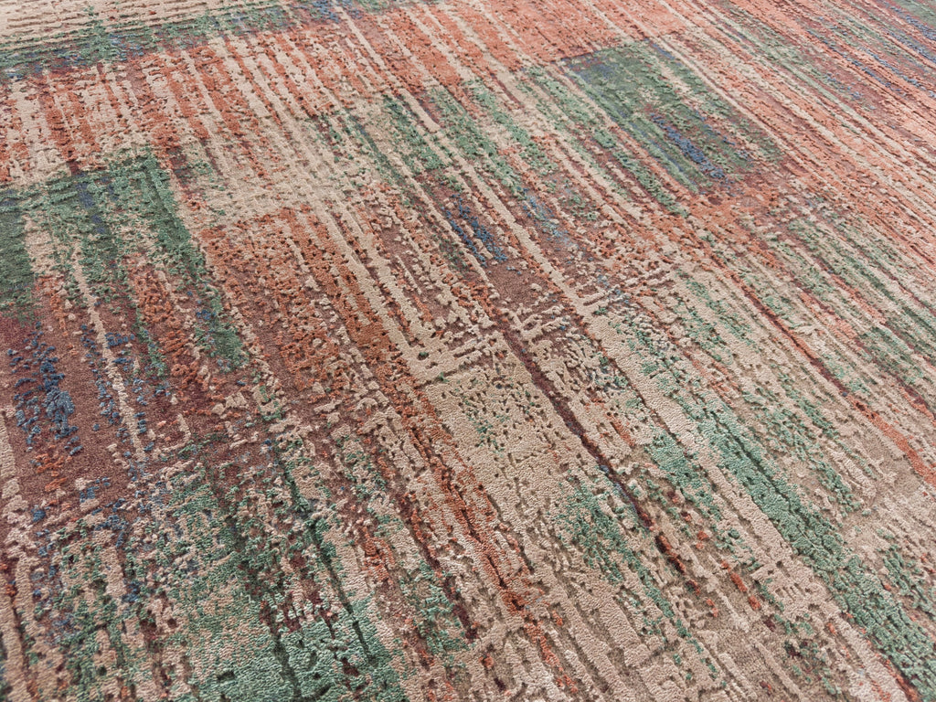 Textured silk rug with modern design and green, blue, red and beige accents.