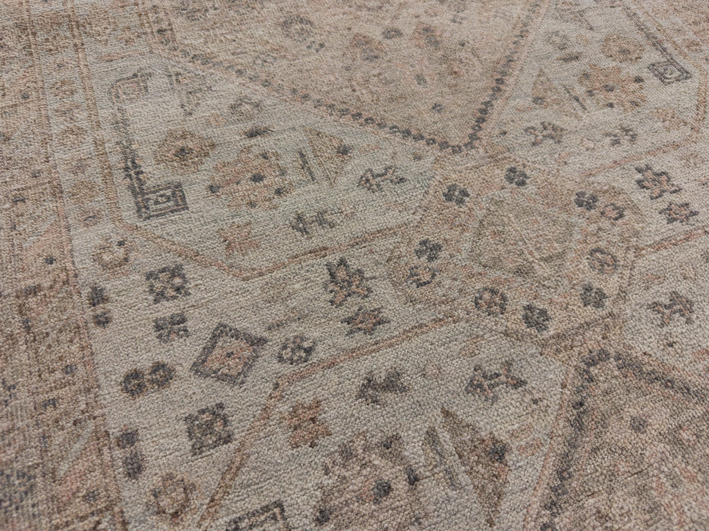 Geometric oriental wool rug with light blue green, grey and blush.