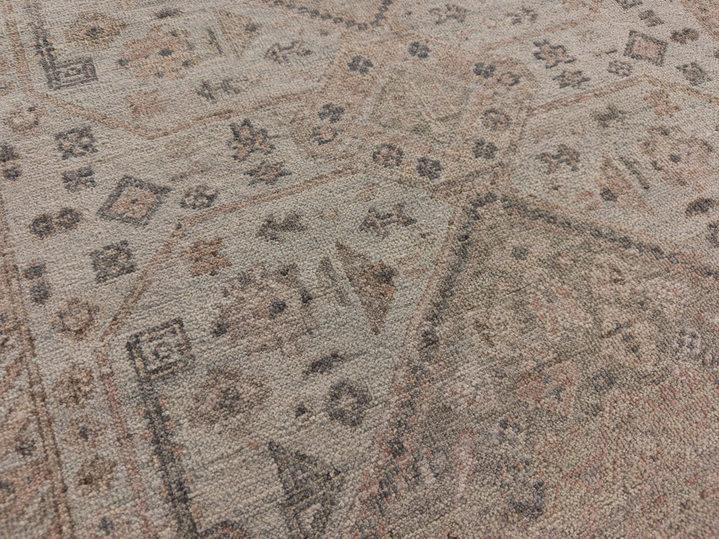 Medallion rug with grey, blush and light blue green.