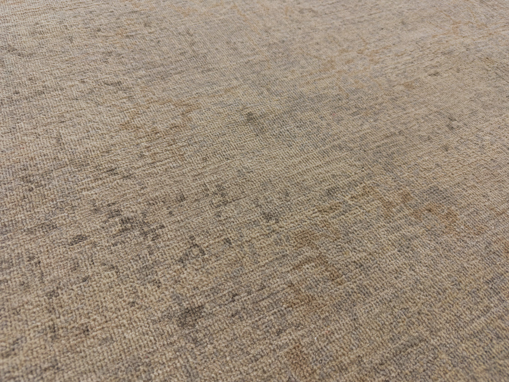 Washed out rug with light grey and neutral accents.