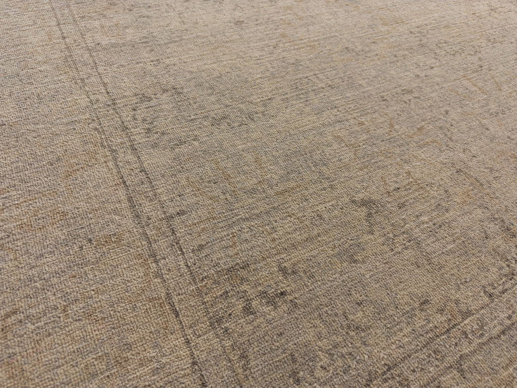 Light washed out oriental rug with grey and warm beige brass color.