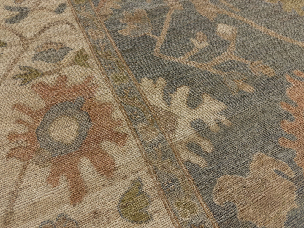 Roya Rugs NC fine hand knotted low pile turkish oriental floral modern Oushak rug 9x12 with grey blue tint and ivory with accent clay, sage green and beige colors.